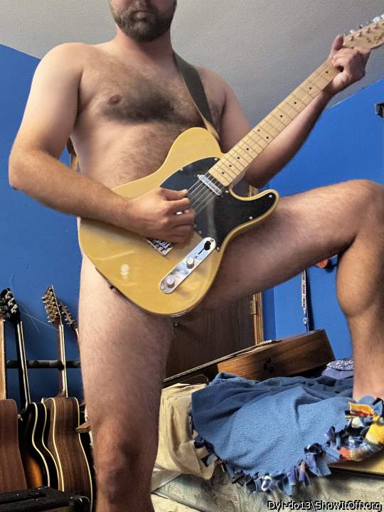 Playing guitar nude
