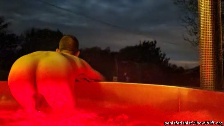 I admire the beautiful cloudy night sky from the large outdoor hot tub.