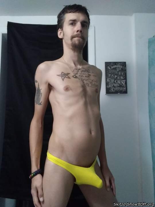 My cock is juting out of my little yellow pouch thong