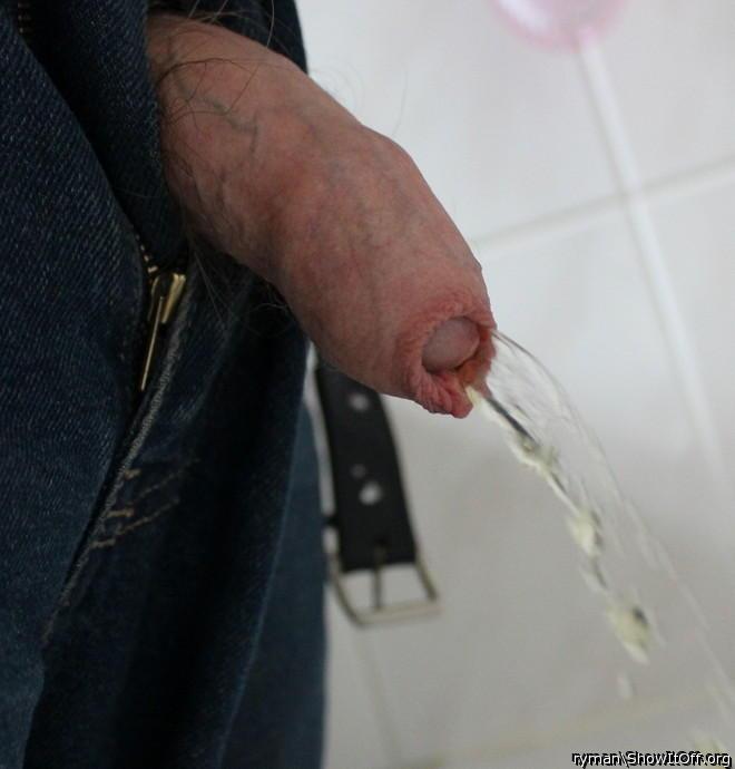 Cock out of jeans having a piss